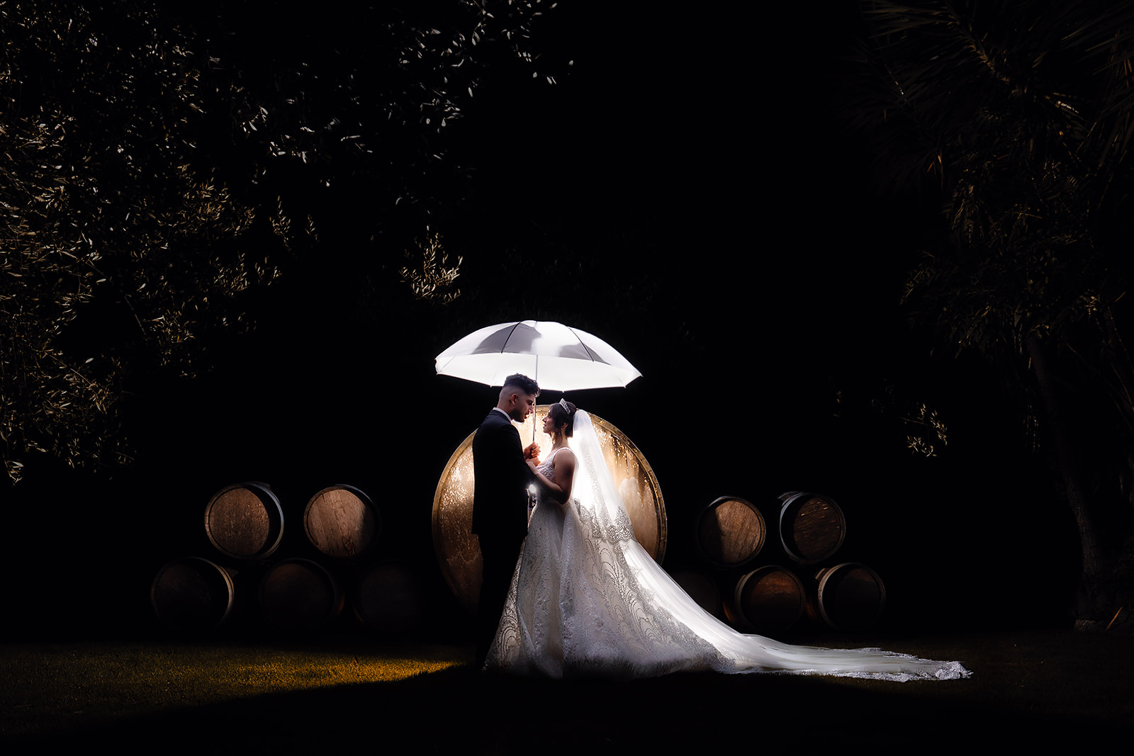 Bride and groom photographed beneath a white umbrella by HAP FILM in Sydney