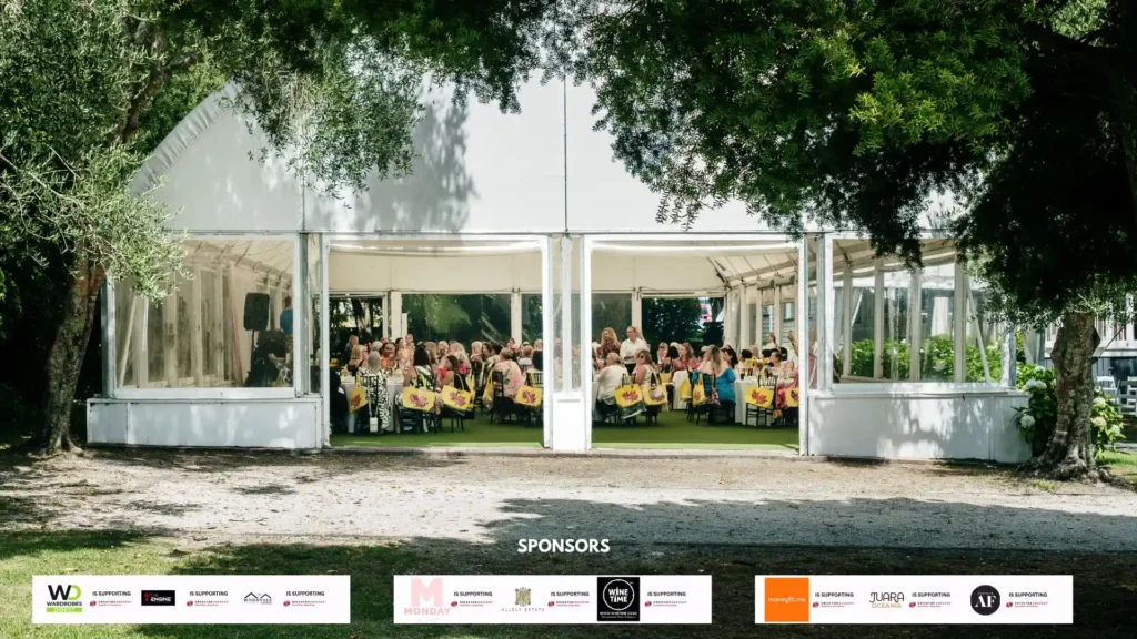 Women dressed in vibrant 70s attire enjoying a Mediterranean-inspired lunch at Allely Estate's 'I Have a Dream, a Song to Sing' event